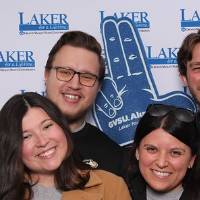 group of four posing together for camera